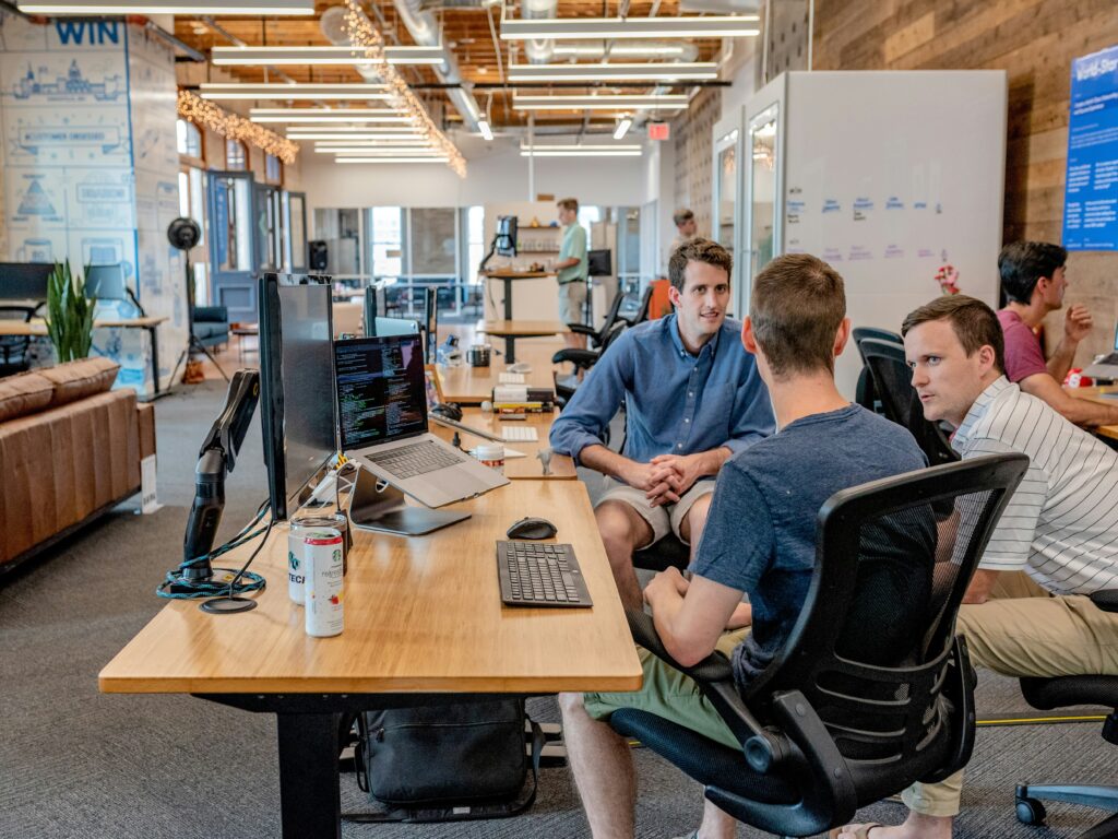 Three sales colleagues seated at desks in an open office